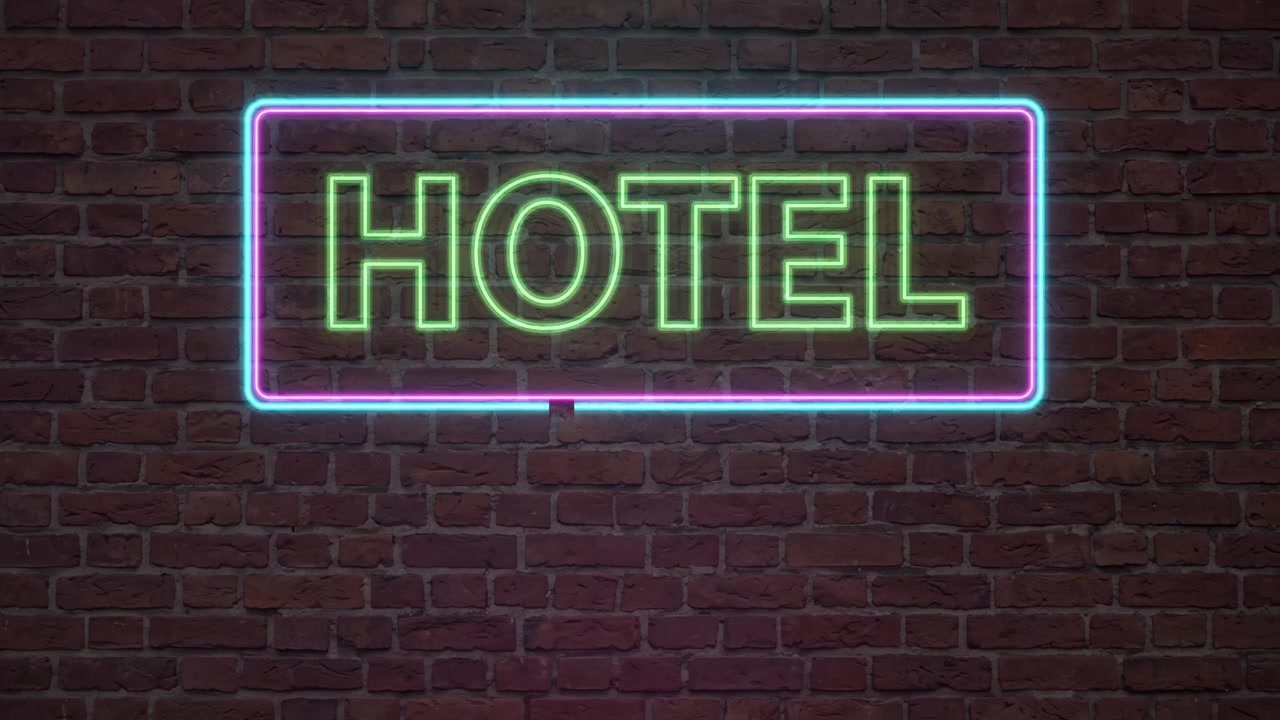 Enseigne néon animée d'hôtel qui brille et scintille sur un fond de mur de briques sombres en boucle.
