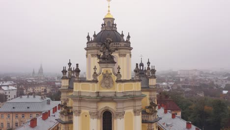 aerial view of a historic church in a foggy city