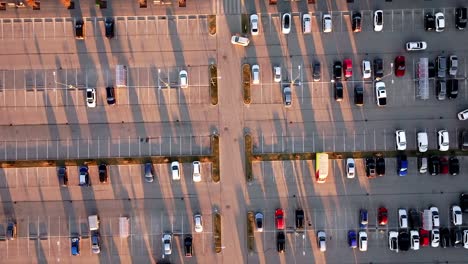 overhead fly-through car navigating lot at golden hour with stretching shadows