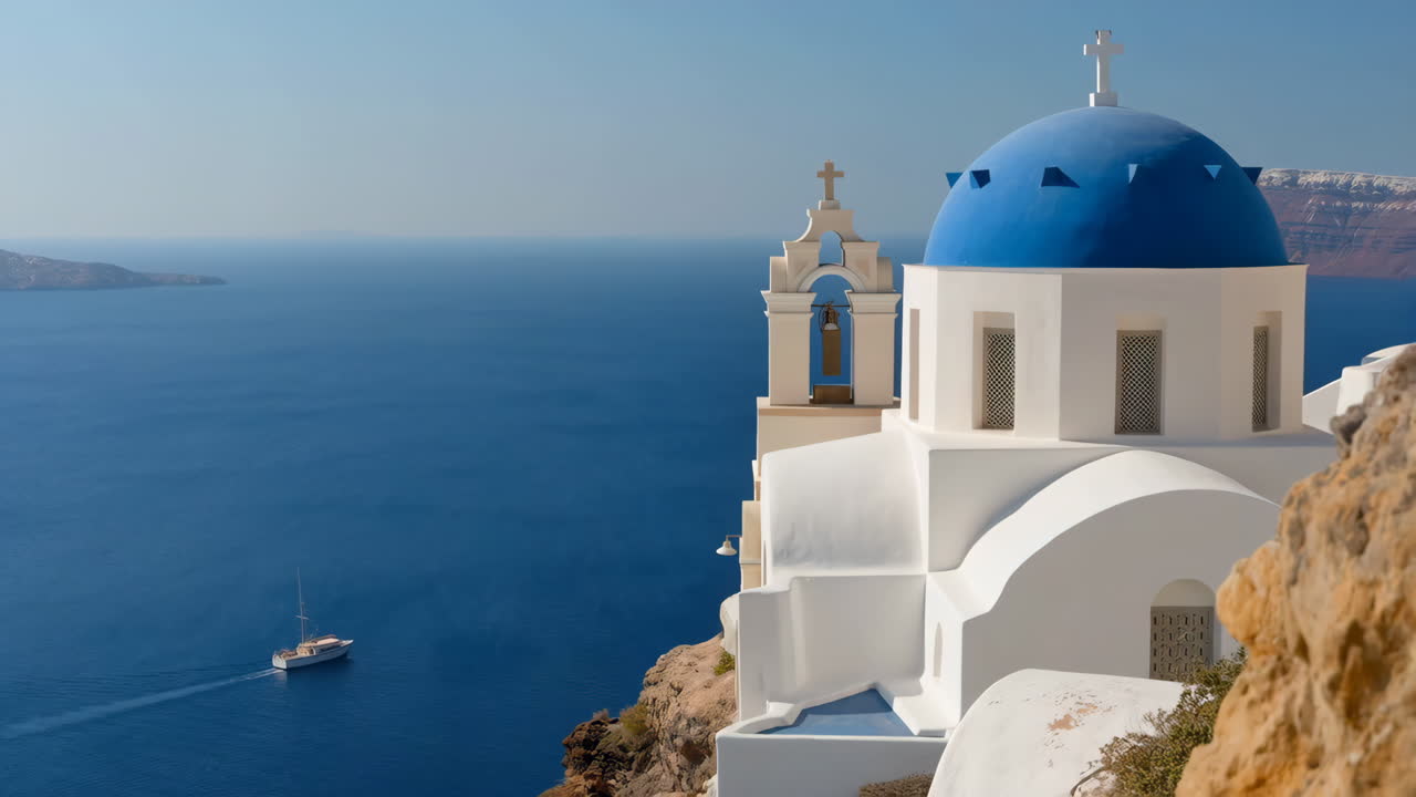 Iconic Blue Domed Church of Santorini Overlooking the Aegean Sea with a Boat