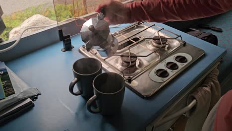 pouring coffee in the campervan, made with a neapolitan coffee maker.
