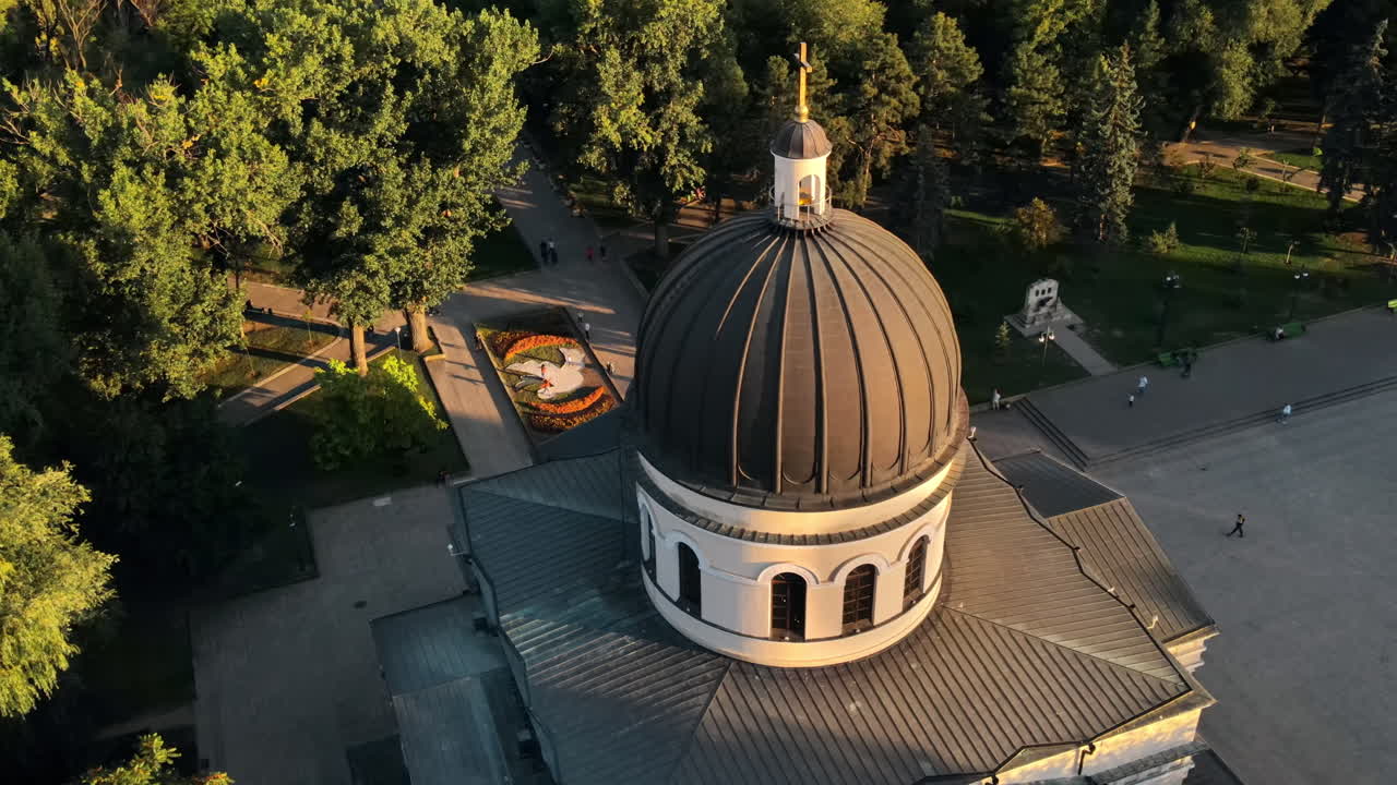 Aerial drone view of Chisinau downtown at sunset. View of central park, Cathedral, bell tower, a lot of greenery, walking people. Moldova