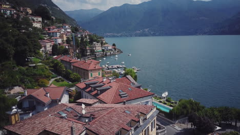 italian lakeside village with boats and mountains