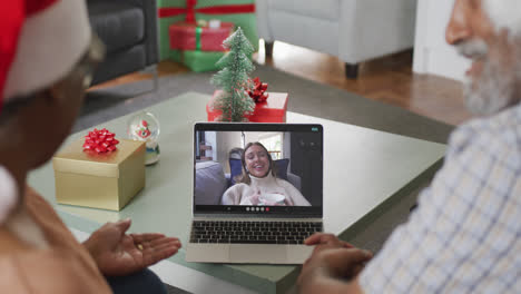 feliz pareja afroamericana senior en videollamada con una amiga en tiempo de navidad