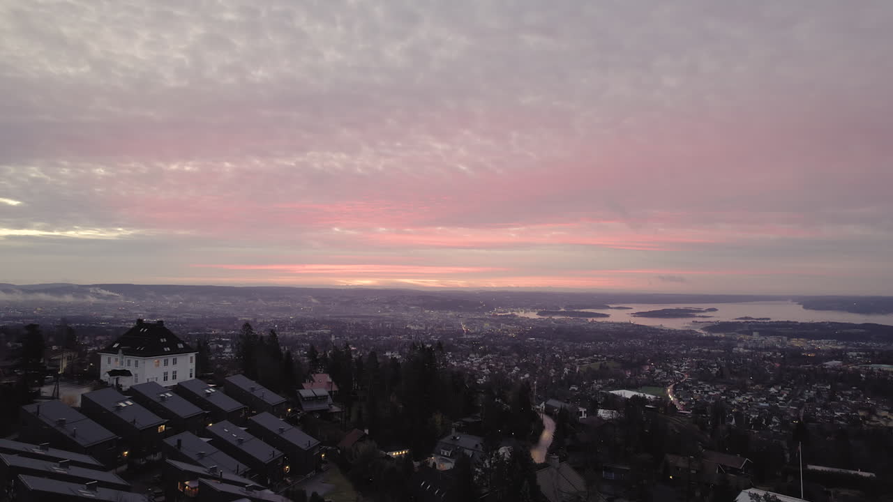 Panoramic Of Cityscape During Sunset Near Holmenkollbakken Ski Jumping Hill In Oslo, Norway. Aerial Shot