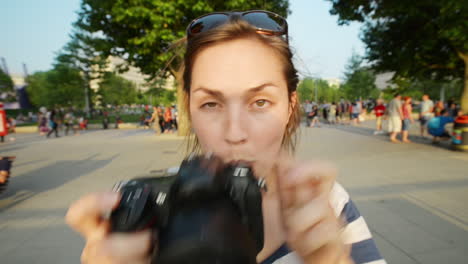 woman taking photo in a park