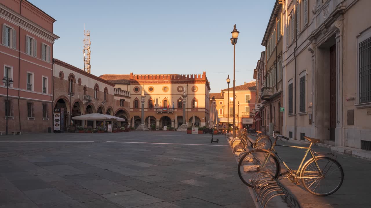Timelapse of the main square Piazza del Popolo with the statues of Saint Apollinare at sunrise , people walking on the center, Ravenna, Italy