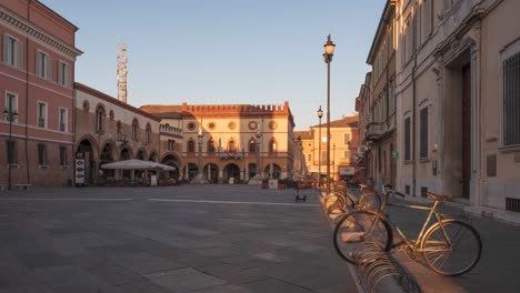 timelapse of the main square piazza del popolo with the statues of saint apollinare at sunrise , people walking on the center, ravenna, italy