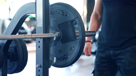 muscular man doing training in gym. fitness man bodybuilder training using barbell in gym