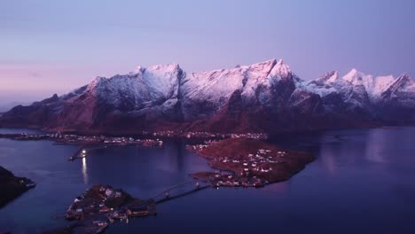 Picturesque-landscape-of-small-town-on-seashore-surrounded-by-massive-mountains