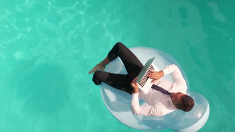 businessman using laptop on inflatble