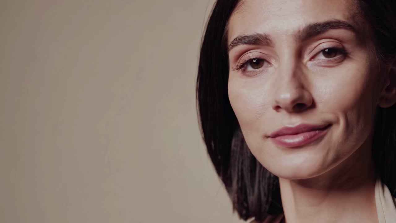 Close-up video of a serene woman with closed eyes, shot from a side angle, capturing a calm