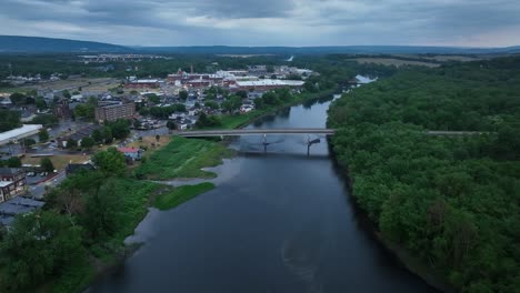 susquehanna river and downtown milton, pennsylvania with drone video moving in and spinning