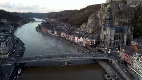 Drone-dolley-shot-of-the-collegiate-church-of-Dinant-next-to-the-river-Maas