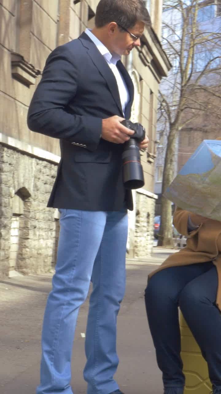 People on the street looking at a map and taking pictures