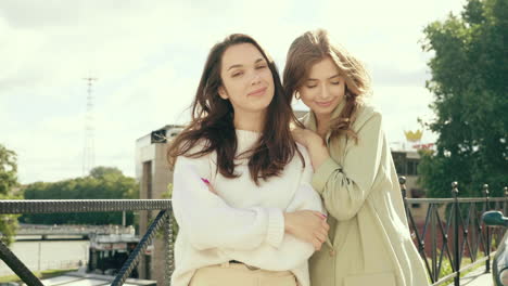 two women friends posing outdoors