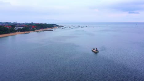 Sailing-Boat-Isolated-At-The-Seascape-Near-Sanur-Town-In-Bali-Island,-Indonesia