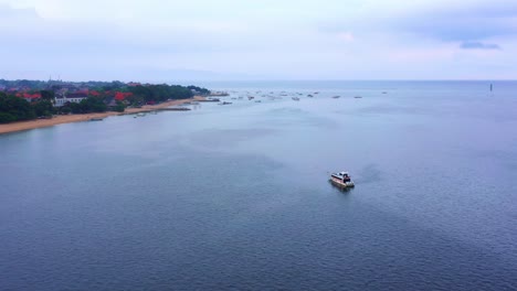 sailing boat isolated at the seascape near sanur town in bali island, indonesia