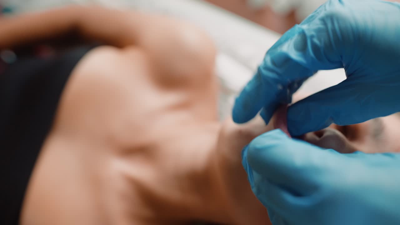 Beautician Performing Lip Augmentation Procedure on Woman's Lips