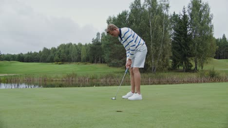 man putting on a golf course