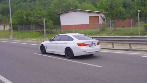 a luxury sports car driving on an asphalt road.