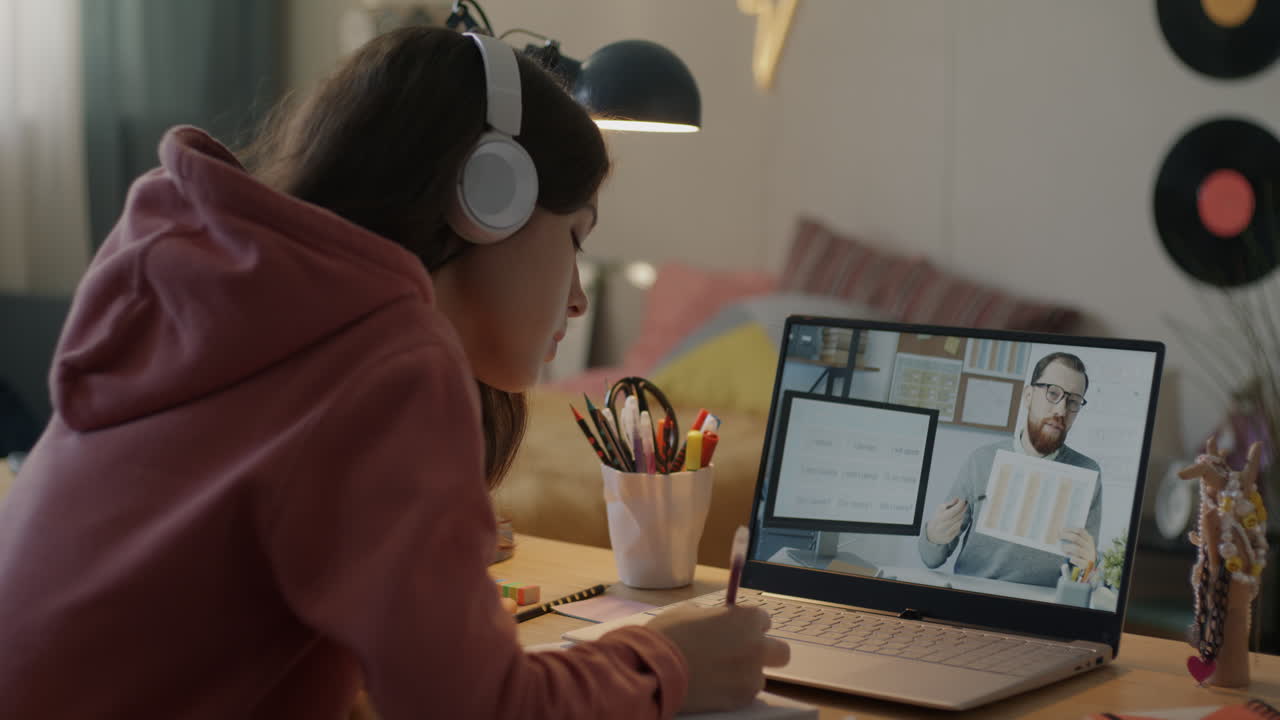 Teenage girl having an online math class