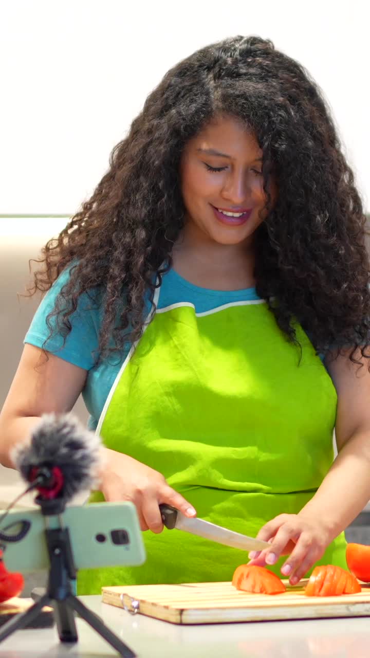 Woman cooking tomato in the kitchen