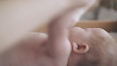 infant boy lies on changing table and enjoys massage