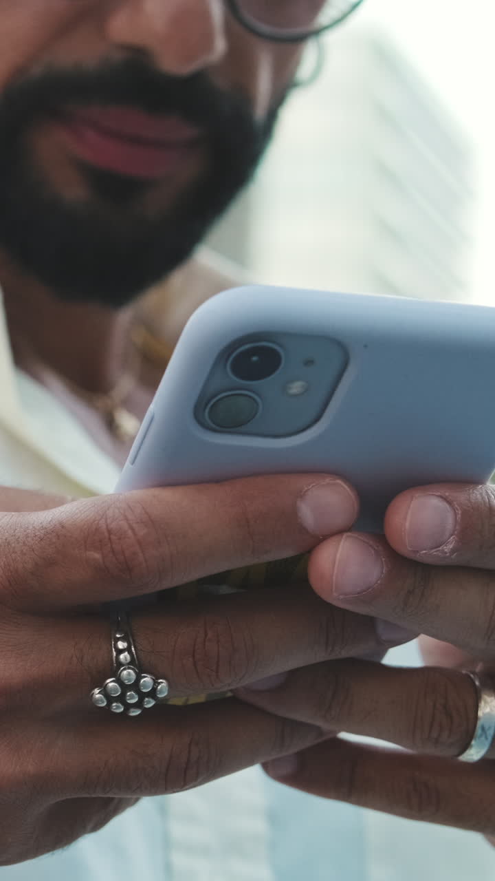 Close-up of Man's Hands Using a Smartphone