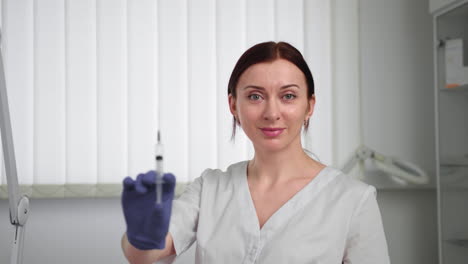 female doctor holding syringe