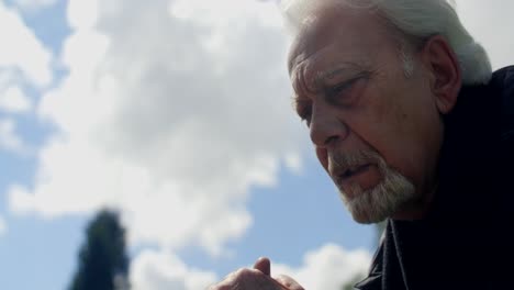 thoughtful senior man outdoors