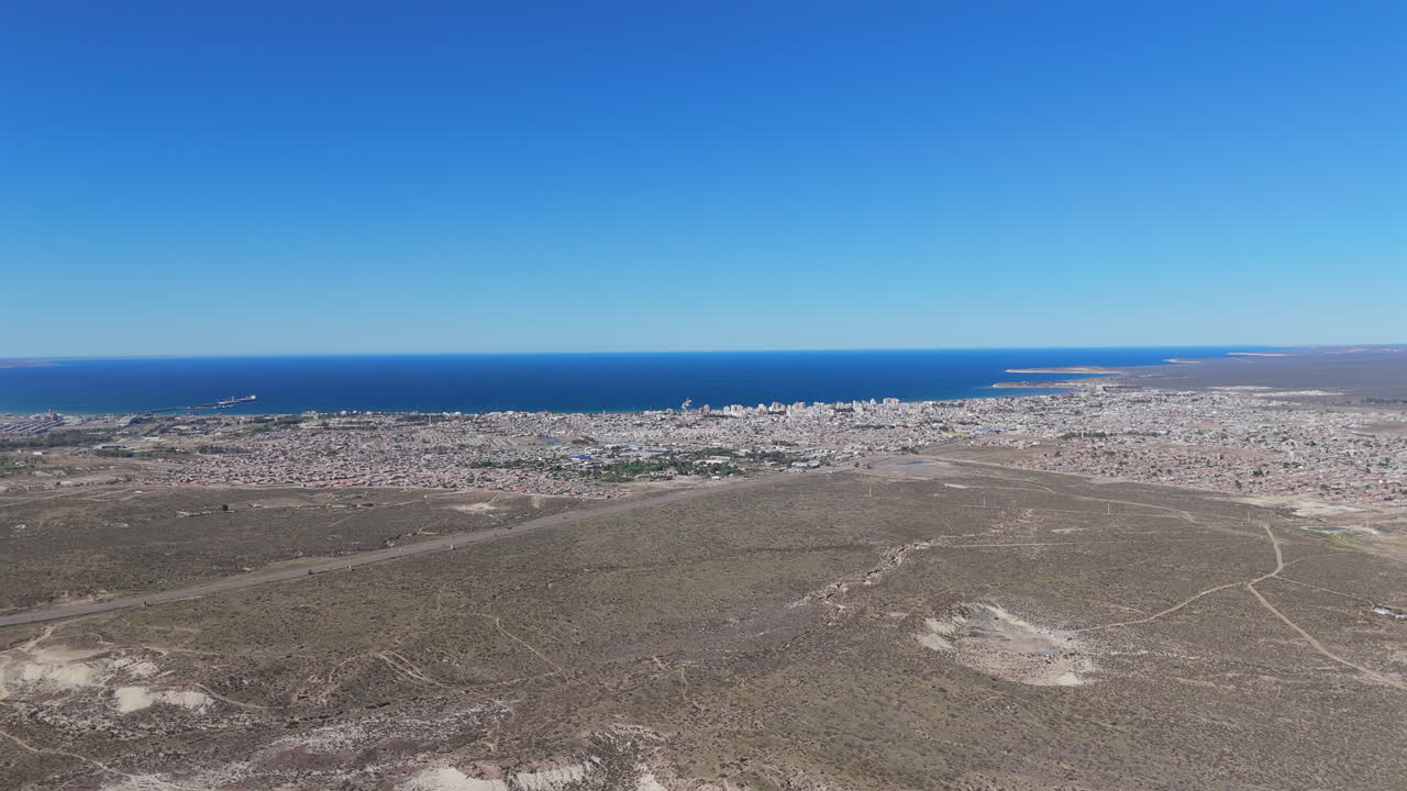 Puerto madryn city, featuring coastal landscape and dry terrain, aerial view