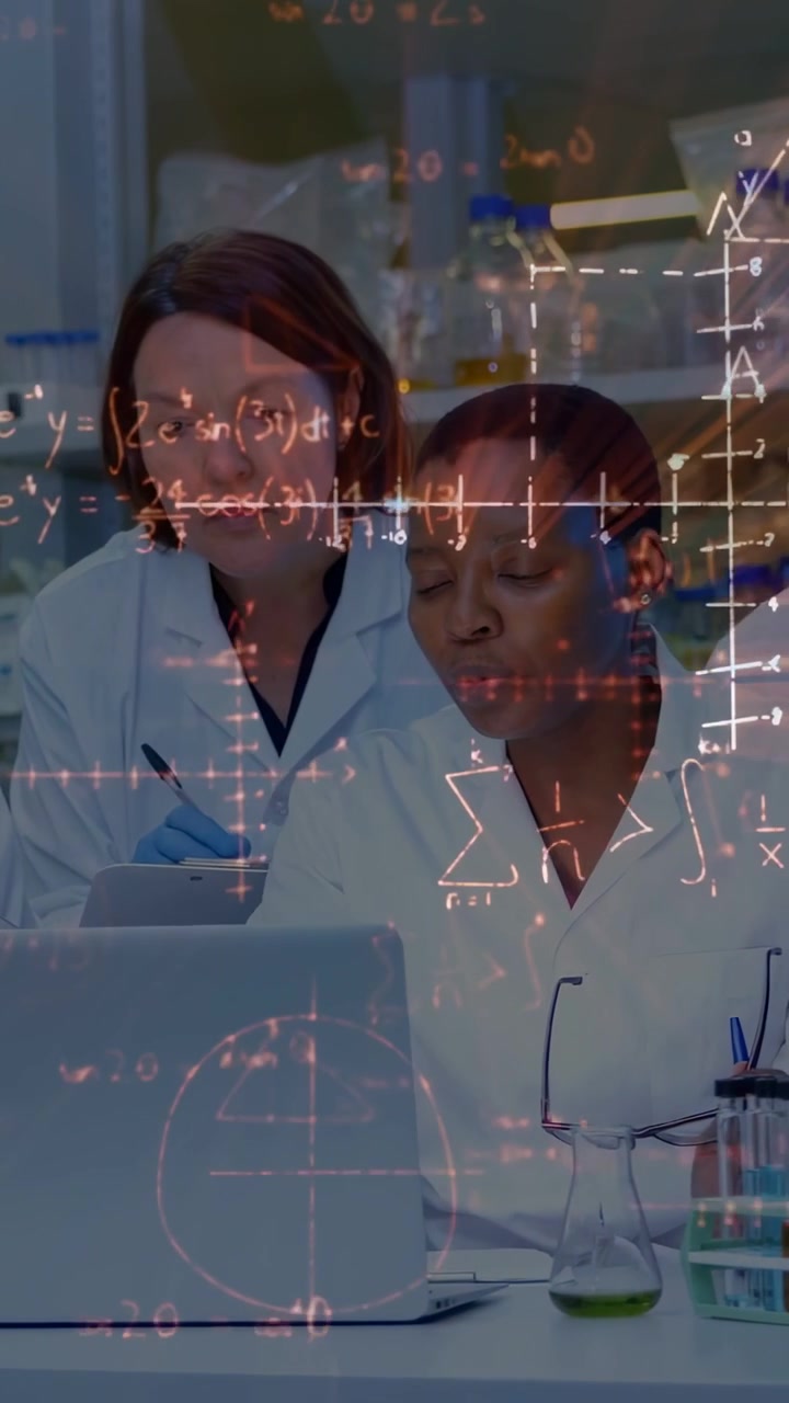 Vertical video: New researcher joining, team leaning in to laptop studying lab data with equations