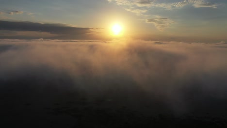 sunrise/sunset through foggy landscape