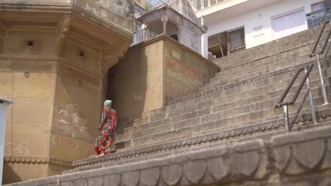 indian woman walking along the ganges ghats