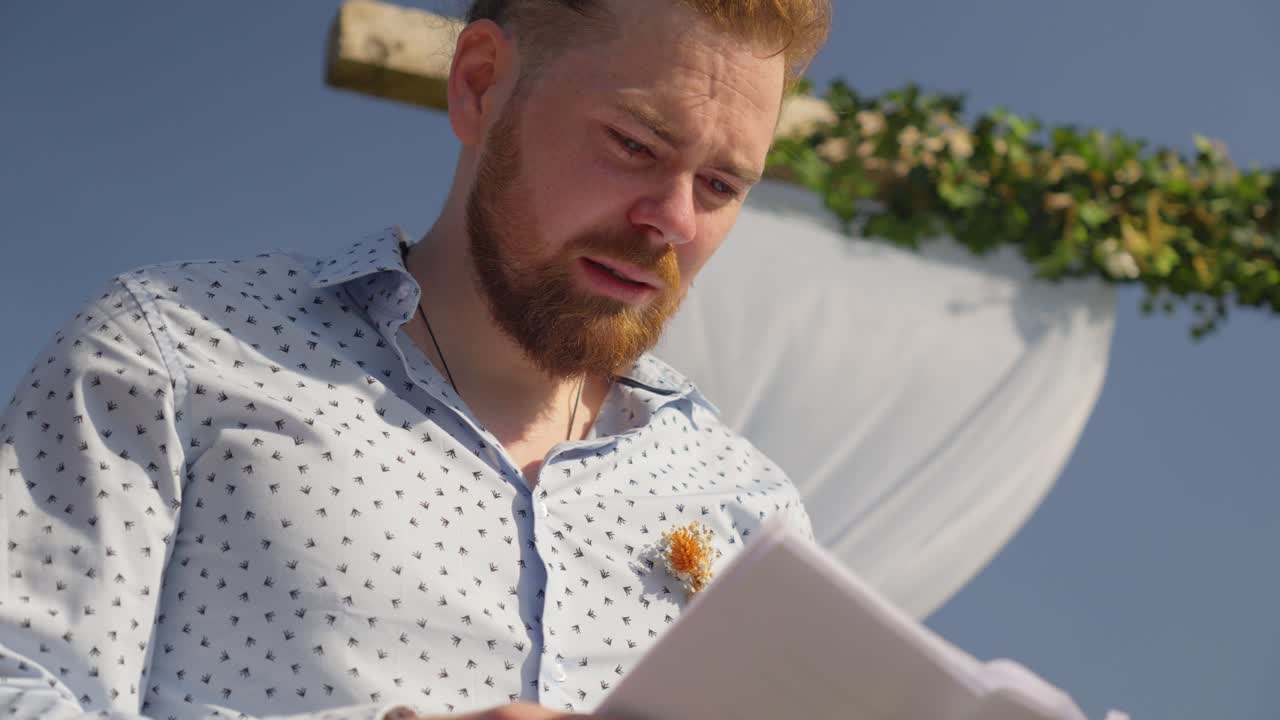 slow motion shot of a groom being emotional whilst reading his wedding vows