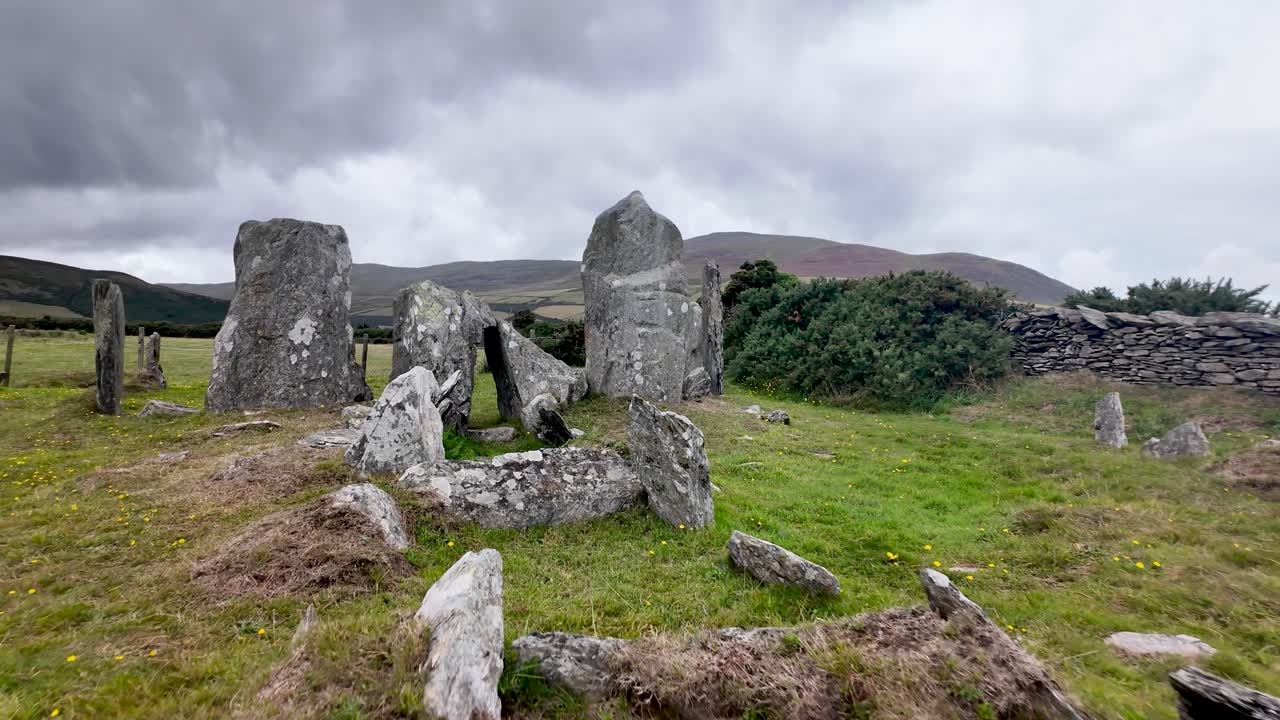 Ancient stone circle and chambered tomb on Manx moor, offering expansive countryside views toward Maughold