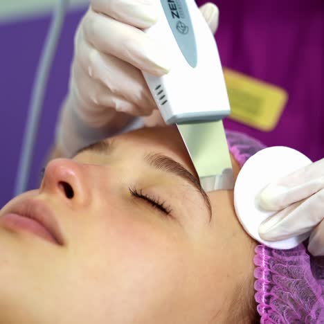 ultrasonic scraber. procedure of ultrasonic cleaning of face. cosmetological clinic. healthcare, clinic, cosmetology. video from the top