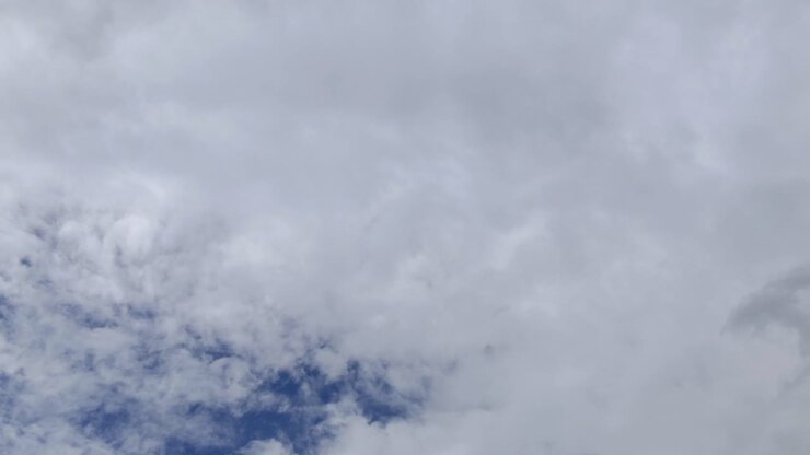 Time lapse shot of blue sky with fast white clouds in movement during summer day