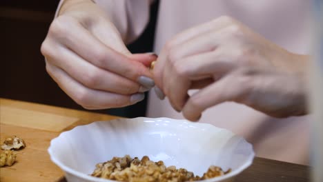 woman mixing walnuts in a bowl