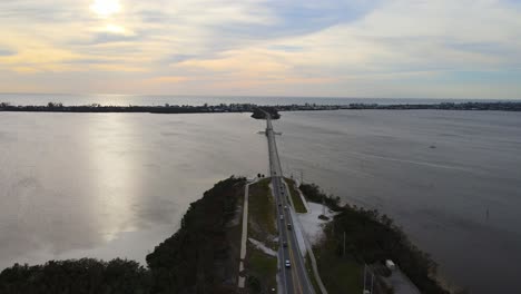 aerial view of a coastal bridge at sunset
