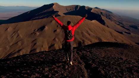 hiker celebrating on a mountain summit