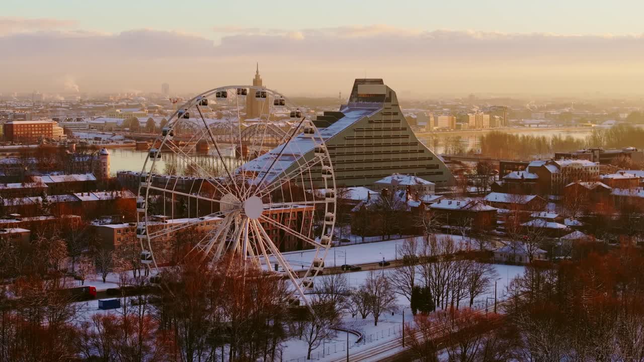 Winter scene in Riga - Ferris wheel, National Library by golden morning light