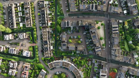 top down aerial view of housing project with condos, apartments, and parking