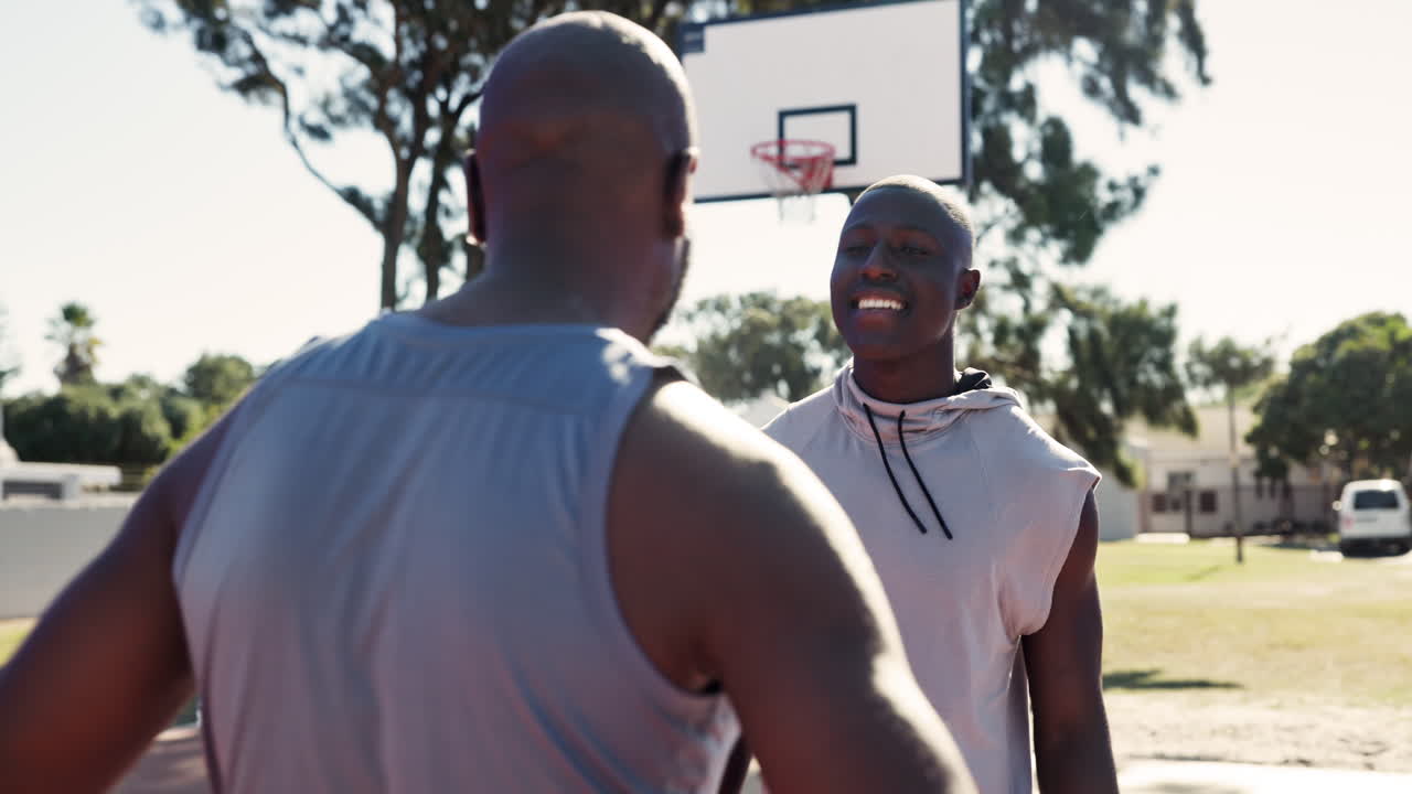 Two friends hugging on the basketball court