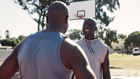 two friends hugging on the basketball court