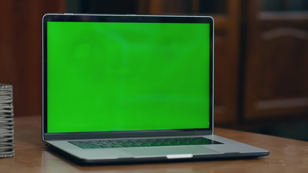 Girl hand pressing key on greenscreen laptop starting video lesson closeup.