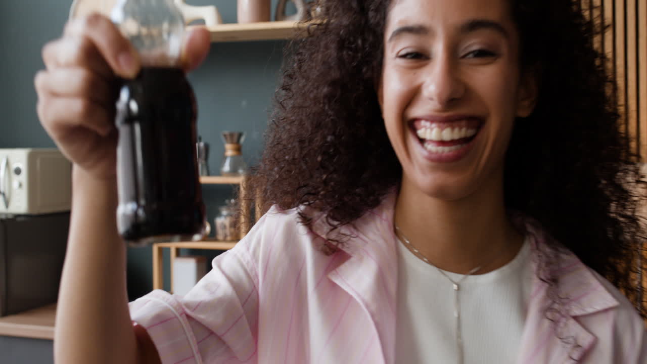 Smiling woman holding a bottle