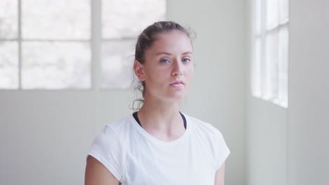 Caucasian-woman-drinking-water-and-looking-at-camera