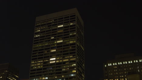 high-rise office buildings illuminated at night in new york city, usa